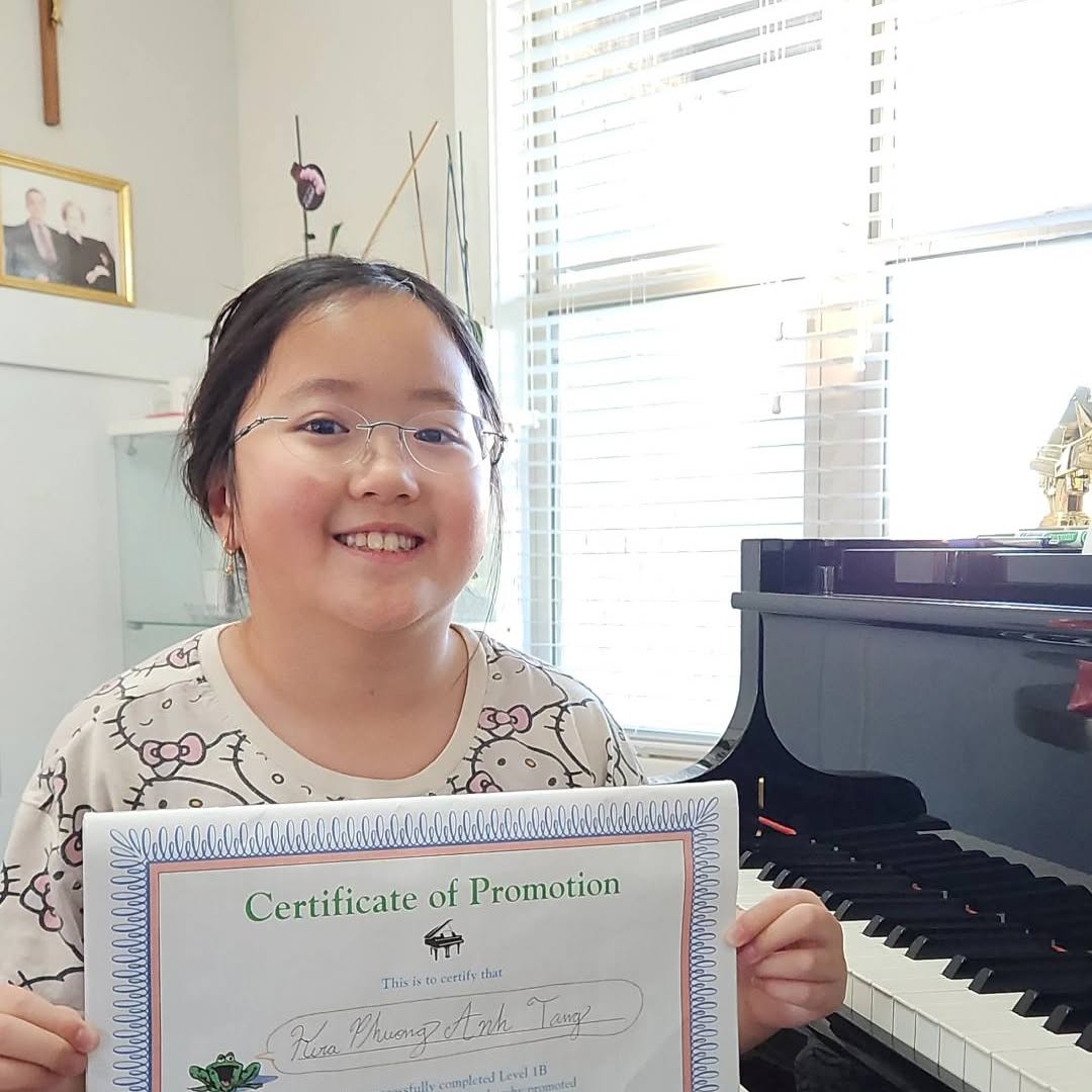 A student smiling with her certificate